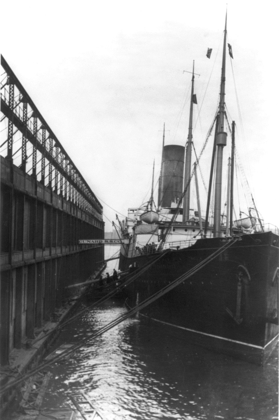 RMS Carpathia docked at Cunard Pier 54 with a crowd gathered on the pier.