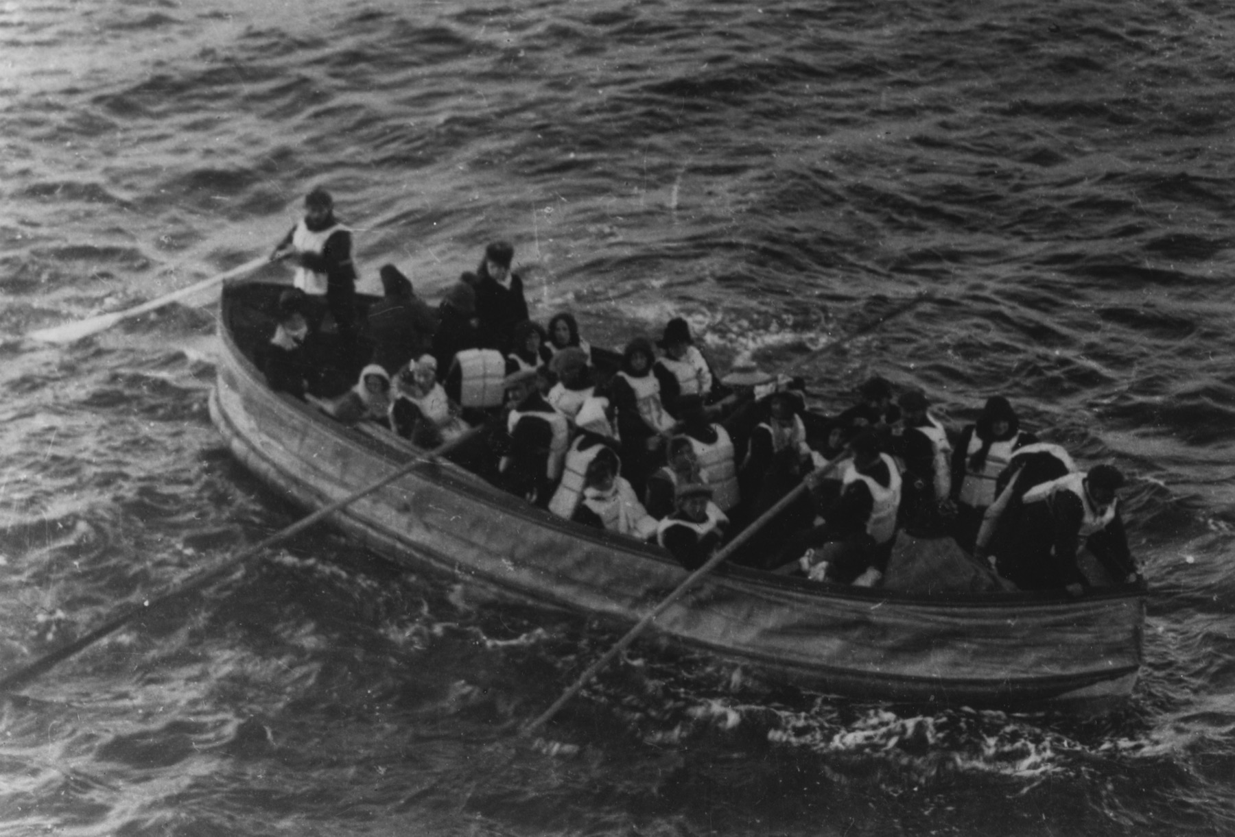 A crowded Titanic lifeboat at sea shortly before rescue by RMS Carpathia.